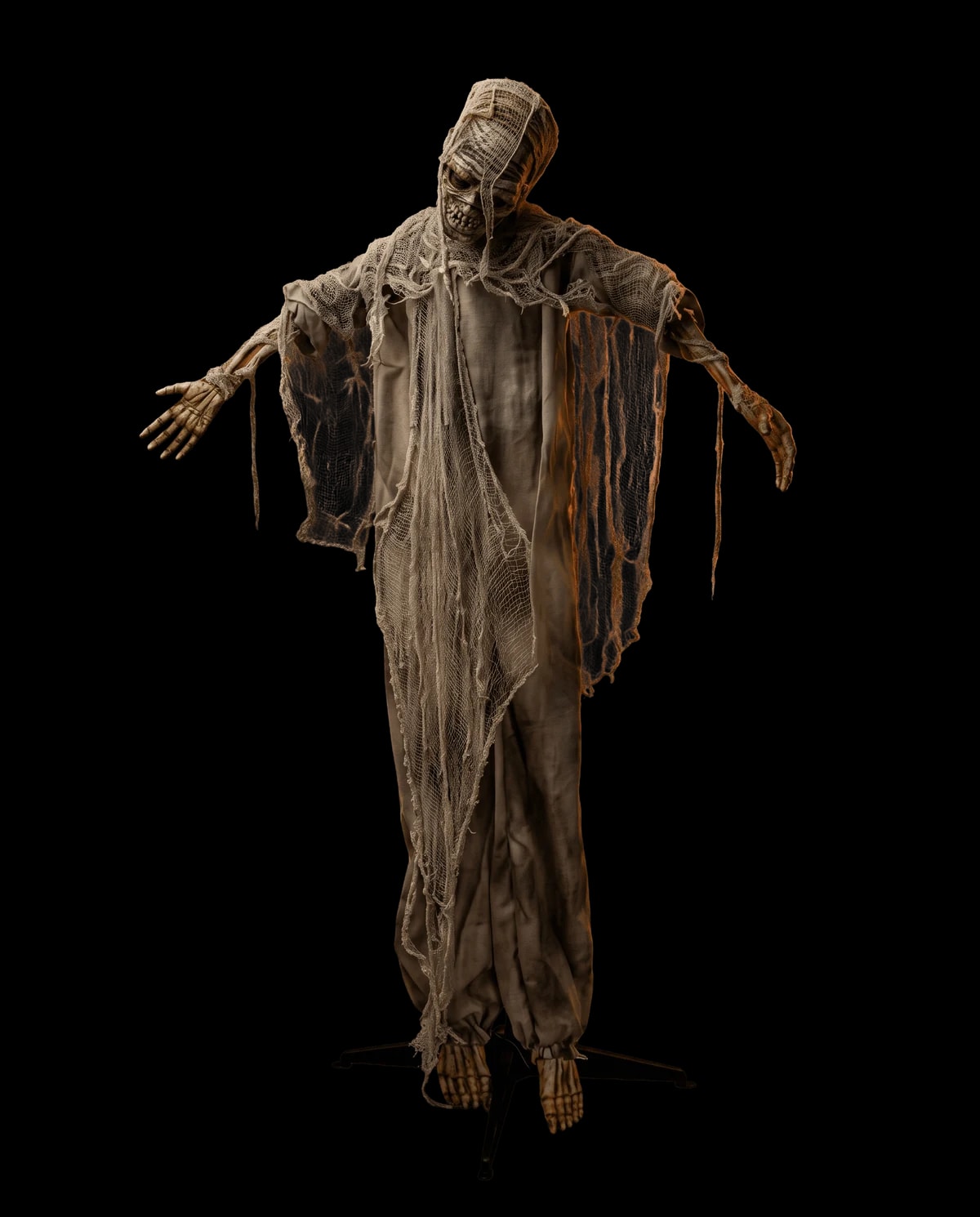 Animatronic prop: a mummy wrapped in aged linen, arms raised.